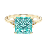 Nature inspired ring featuring princess cut paraiba tourmalines and round diamonds for a magical, color-shifting effect.