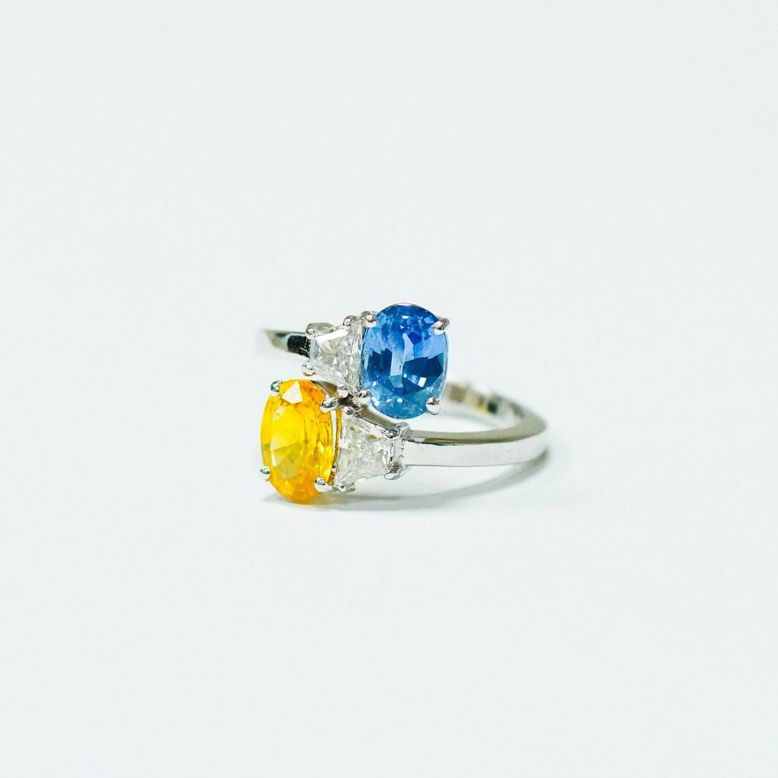 Stunning lab-created blue sapphire and yellow sapphire engagement ring set in a handcrafted white gold band—an ethical and luxurious diamond alternative.