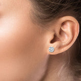 Close-up of an ear wearing a diamond stud earring.