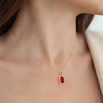 Gold necklace with a red ruby gemstone pendant for women.