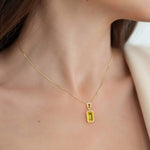 Sparkling gold necklace with a yellow gemstone pendant, elegant custom jewelry by Pel & Co.