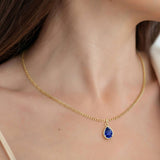Woman wearing Pear Blue Sapphire Solitaire Pendant Necklace 14x10mm 8 Carat in 14K Gold with Cable Curb Chain