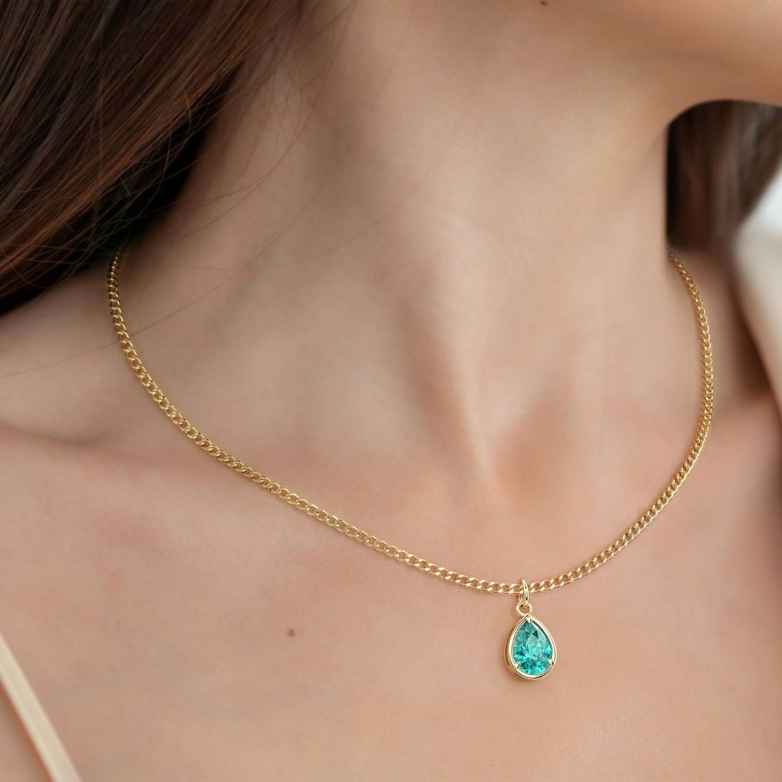 Woman wearing Pear Paraiba Tourmaline Necklace Solitaire Pendant 14x10mm 8 Carat in 14K Gold with Cable Curb Chain