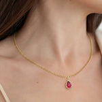 Woman wearing Pear Ruby Solitaire Pendant Necklace 14x10mm 8 Carat in 14K Gold with Cable Curb Chain