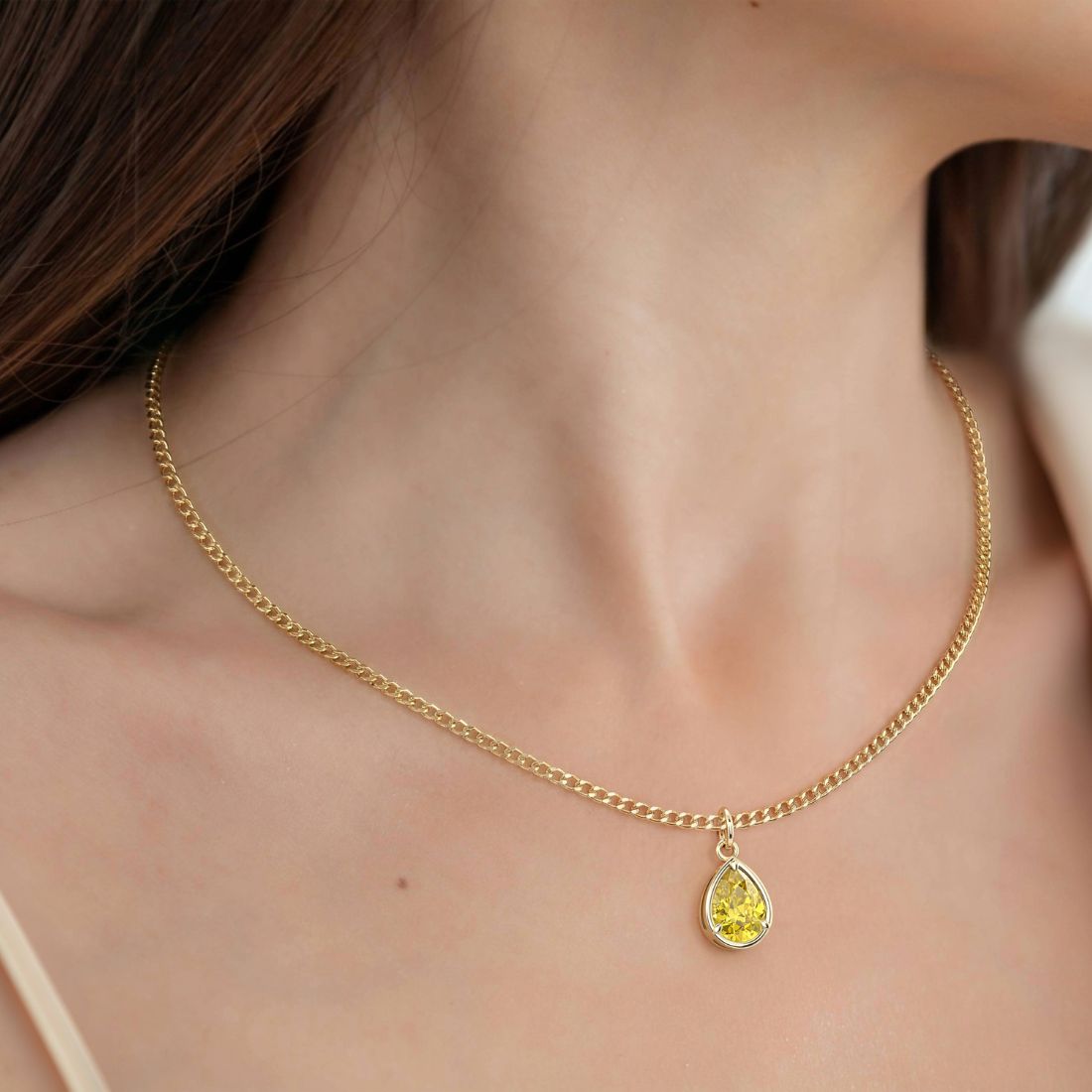 Woman wearing Pear Yellow Sapphire Solitaire Pendant Necklace 14x10mm 8 Carat in 14K Gold with Cable Curb Chain