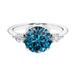 3 stone alexandrite and diamond engagement ring with round center, symbolizing past, present, and future.