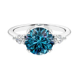 3 stone alexandrite and diamond engagement ring with round center, symbolizing past, present, and future.
