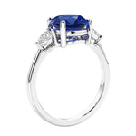 3 stone wedding ring featuring round blue sapphire center diamond and matching sides.