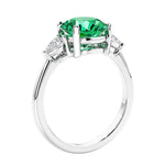 3 stone wedding ring featuring round colombian emerald center diamond and matching sides set in 14k white gold.