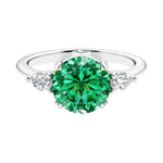 3 stone colombian emerald and diamond engagement ring with round center, symbolizing past, present, and future, set in 14k white gold.