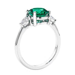 3 stone wedding ring featuring round emerald center diamond and matching sides set in 14k white gold.