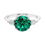 3 stone emerald and diamond engagement ring with round center, symbolizing past, present, and future, set in 14k white gold.