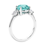 3 stone wedding ring featuring round paraiba green tourmaline center diamond and matching sides set in 14k white gold.