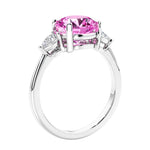 3 stone wedding ring featuring round pink sapphire center diamond and matching sides set in 14k white gold.