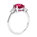 3 stone wedding ring featuring round red ruby center diamond and matching sides set in 14k white gold.
