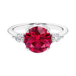 3 stone red ruby and diamond engagement ring with round center, symbolizing past, present, and future, set in 14k white gold.