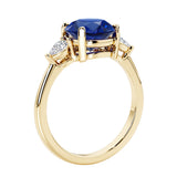 3 stone round diamond ring in classic yellow gold setting.