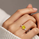 Woman wearing handcrafted round center gemstone engagement ring with sparkling diamond sides.