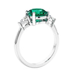 Round emerald 3 stone engagement ring in white gold—a refined and popular choice among lab grown engagement rings.