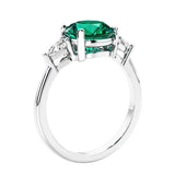 Round emerald 3 stone engagement ring in white gold—a refined and popular choice among lab grown engagement rings.