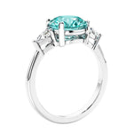 Round paraiba tourmaline 3 stone engagement ring in white gold—a refined and popular choice among lab grown engagement rings.