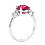 Round red ruby 3 stone engagement ring in white gold—a refined and popular choice among lab grown engagement rings.