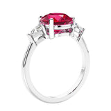 Round red ruby 3 stone engagement ring in white gold—a refined and popular choice among lab grown engagement rings.