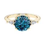 Handcrafted round center gemstone engagement ring with sparkling diamond sides.