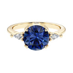Handcrafted round center blue sapphire engagement ring with sparkling diamond sides.