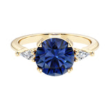 Handcrafted round center blue sapphire engagement ring with sparkling diamond sides.