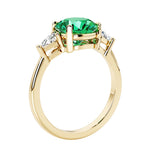 Lab diamond engagement ring with round colombian emerald center and two sparkling diamond side stones for timeless beauty.