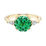 Handcrafted round center colombian emerald engagement ring with sparkling diamond sides.