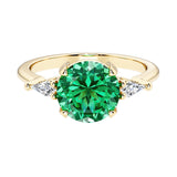 Handcrafted round center colombian emerald engagement ring with sparkling diamond sides.