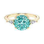 Handcrafted round center paraiba tourmaline engagement ring with sparkling diamond sides.