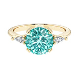 Handcrafted round center paraiba tourmaline engagement ring with sparkling diamond sides.