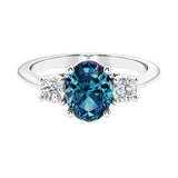 Three stone oval cut real alexandrite and diamond ring in classic design.