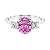 Three stone oval cut real pink sapphire and diamond ring in classic design.