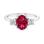 Three stone oval cut real ruby and diamond ring in classic design.