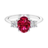 Three stone oval cut real ruby and diamond ring in classic design.