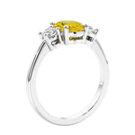 Oval cut three stone fancy yellow diamond look yellow sapphire and diamond engagement ring with romantic charm.