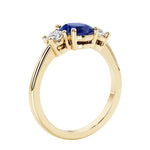 3 stone wedding ring with oval center gemstone and diamond side stones.
