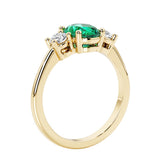 3 stone wedding ring with oval center gemstone and diamond side stones.