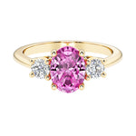 Oval 3 stone engagement ring with pink sapphire and brilliant diamond side stones.