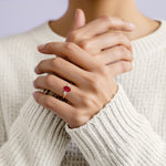 Woman wearing oval shaped 3 stone engagement ring with soft sparkle.