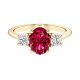 Oval 3 stone engagement ring with red ruby and brilliant diamond side stones.