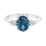 Three stone oval and pear shaped real alexandrite and diamond ring in classic design.