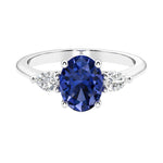 Three stone oval and pear shaped real blue sapphire and diamond ring in classic design.