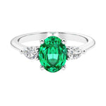 Three stone oval and pear shaped real colombian emerald and diamond ring in classic design.