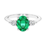 Three stone oval and pear shaped real colombian emerald and diamond ring in classic design.