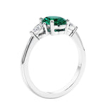 Oval cut three stone real green emerald and diamond engagement ring with romantic charm.